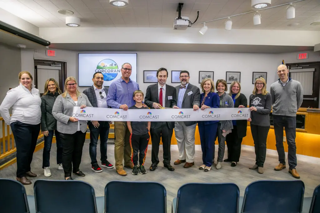 Group of people at ribbon cutting ceremony in Corcoran, Minn.