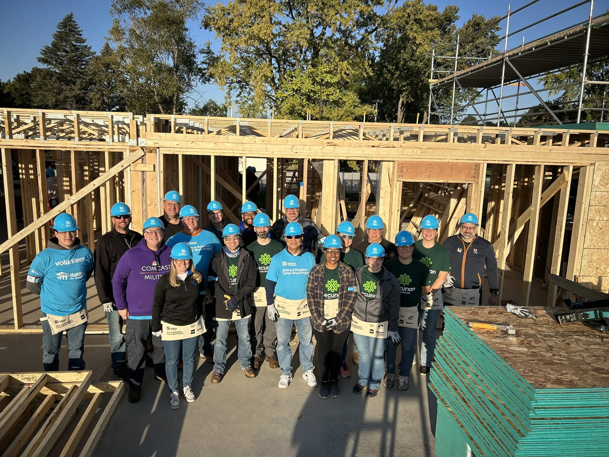 Group of Comcast employees volunteering at Habitat for Humanity