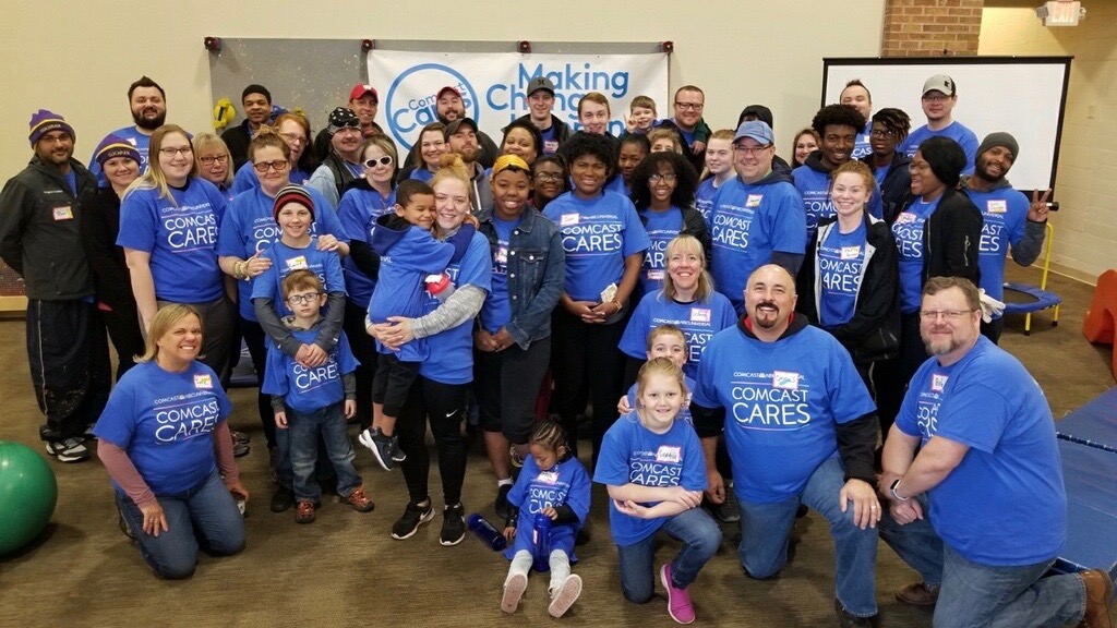 A large group of smiling Comcast Cares Day volunteers.