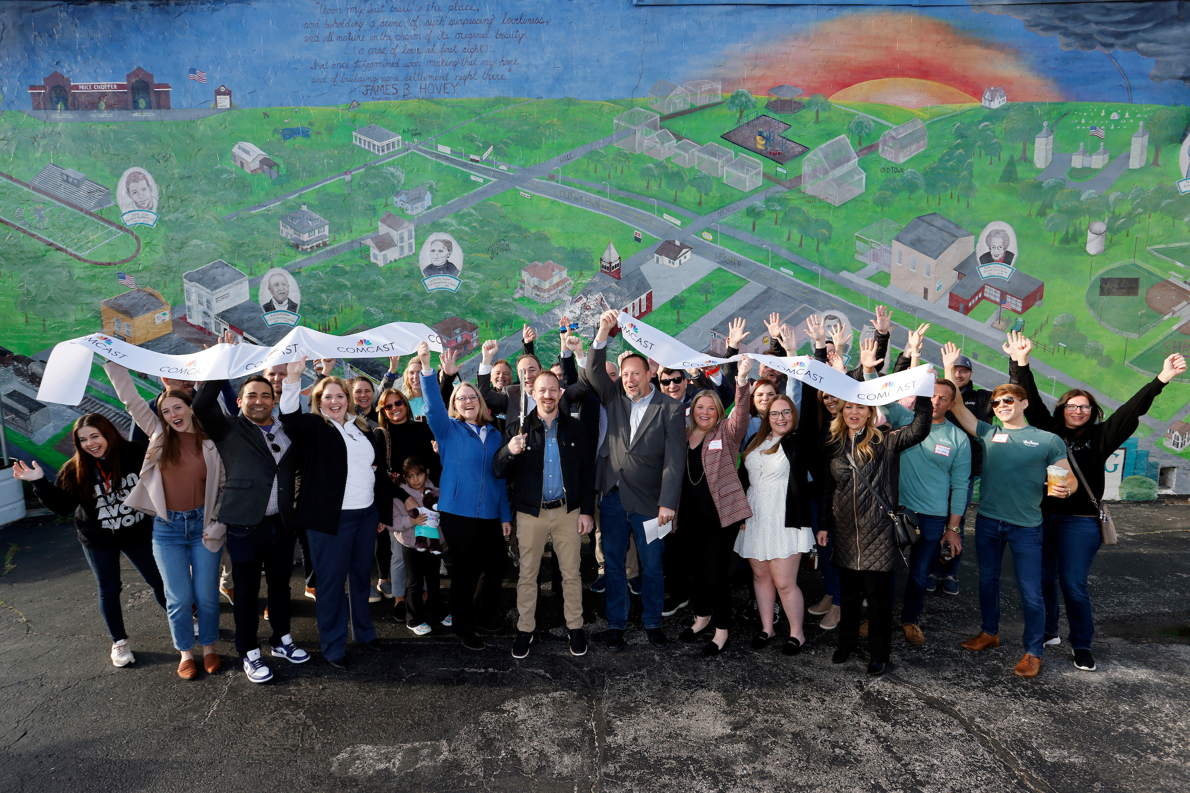 Comcast employees along with city and state officials celebrate after a ribbon cutting at the Spring Hill Chamber of Commerce on Friday, April 19, 2024 in Spring Hill, Kan.