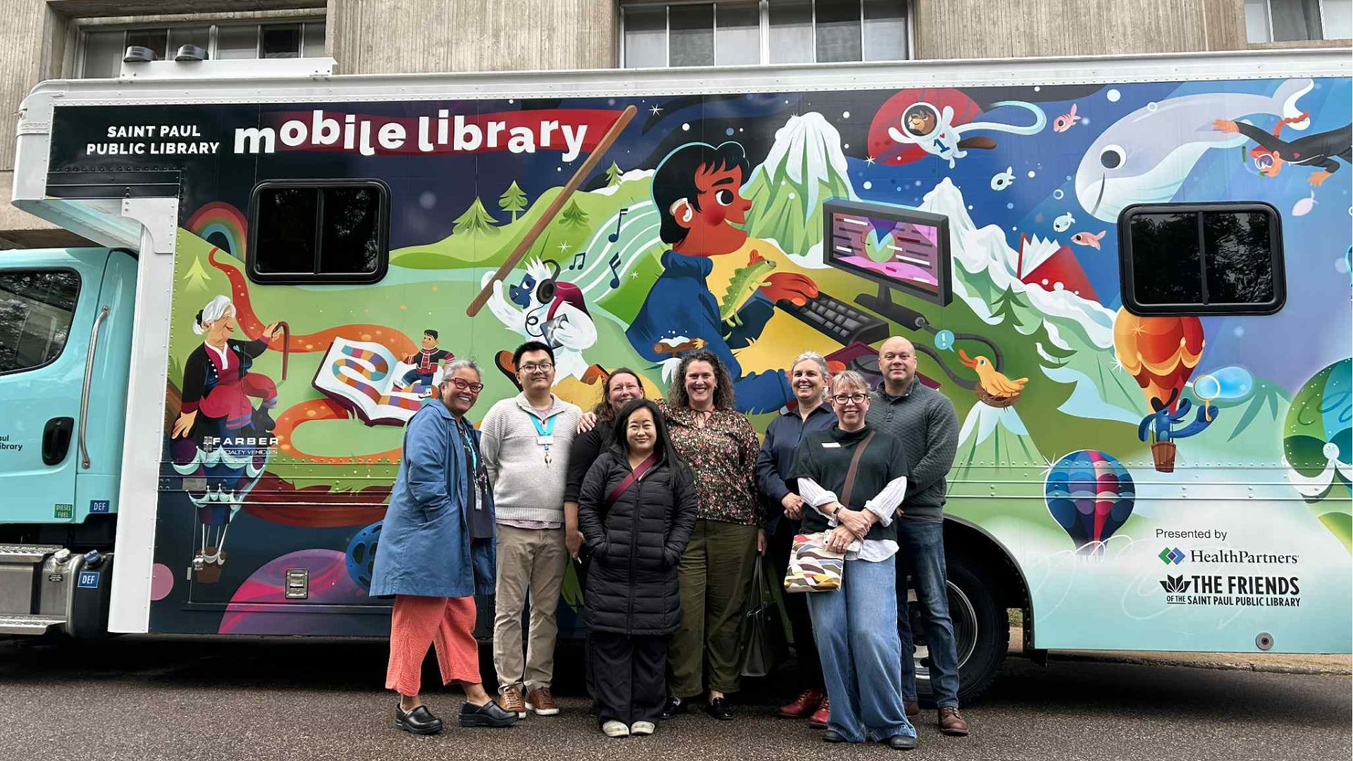 Group of people standing in front of the St. Paul Public Library's Mobile Library